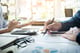 two people sitting at table working