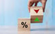 percentage sign with a red decrease arrow