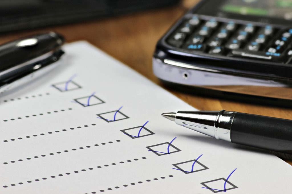 piece of paper on desk with checkboxes marked