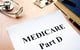 Medicare Part D written on paper on desk with stethoscope and medication