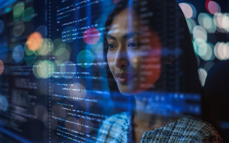 woman with computer code in front of her face