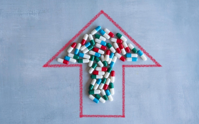 red arrow pointing up filled in with prescription drugs