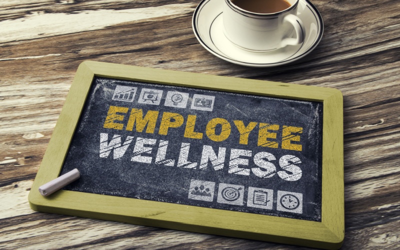 chalkboard on table that reads employee wellness