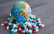 globe with prescription drugs around it
