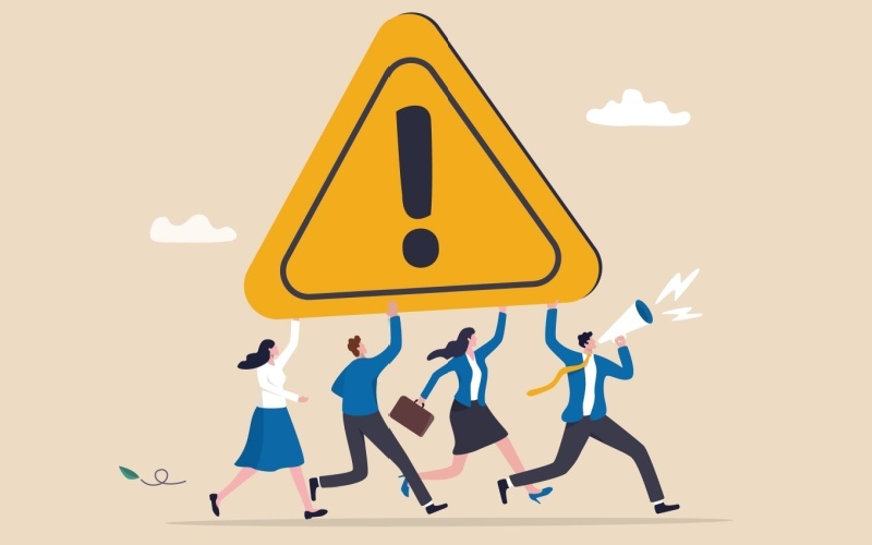 people running and carrying large yellow exclamation point sign