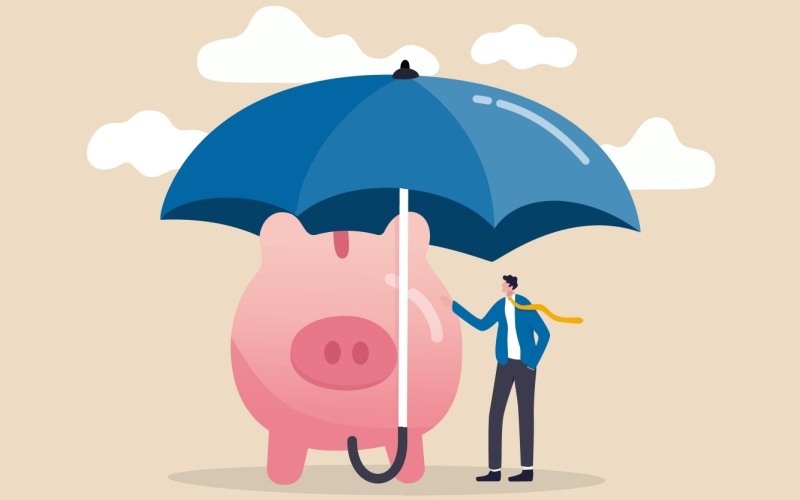 piggy bank and man standing under umbrella