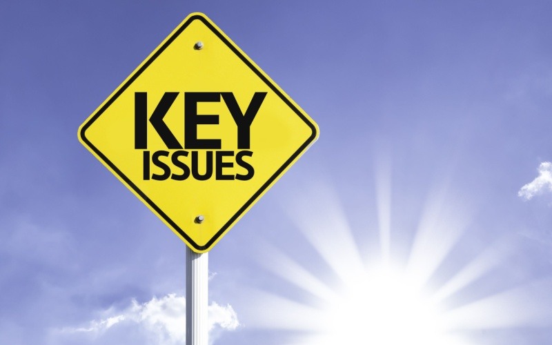 yellow sign that reads key issues