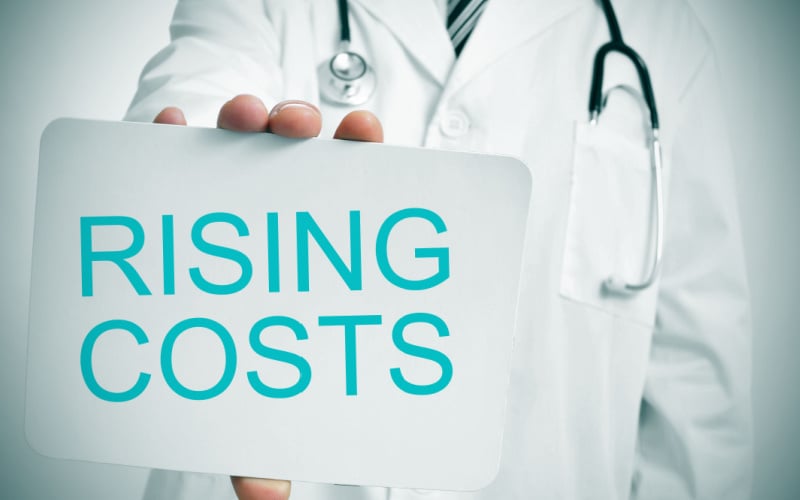 doctor holding rising costs sign