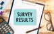 clipboard on desk that reads survey results