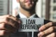 young businessman holding card that says loan repayment