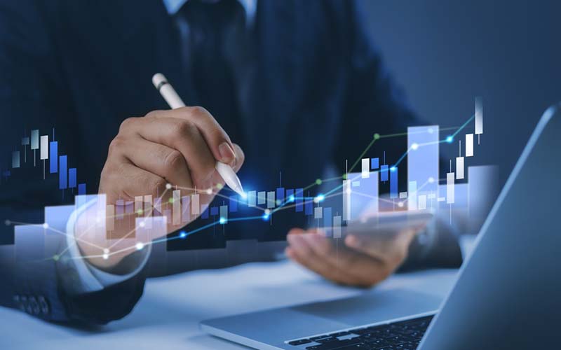 person on computer with charts and icons