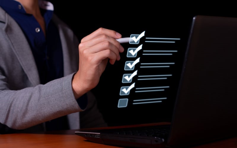 man marking off checklist