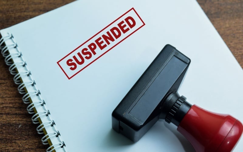 suspended stamped onto notebook