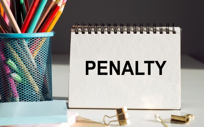 notebook sitting on desk that reads penalty