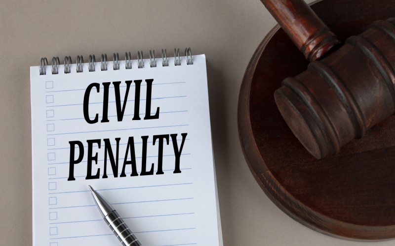 civil penalty words in notebook with judge's hammer