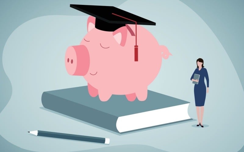 pig wearing graduation cap sitting on a book