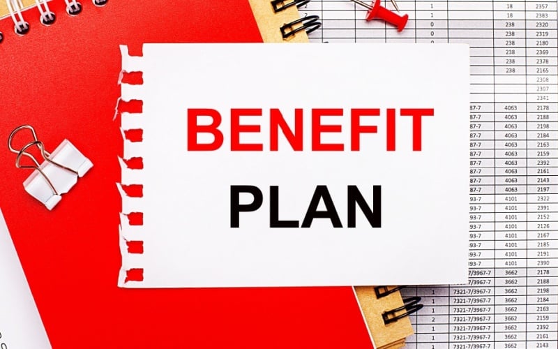 Benefit plan written on torn notebook paper with other documents