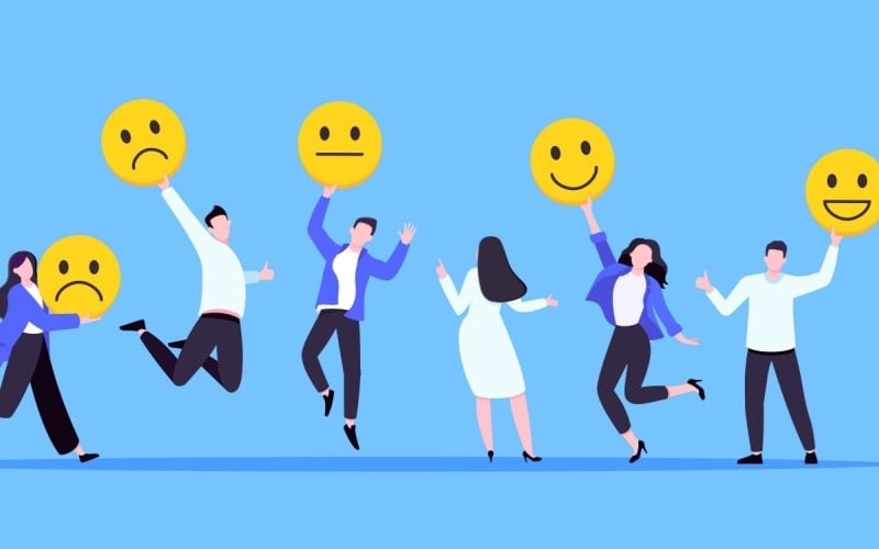 employees holding up different feelings emojis