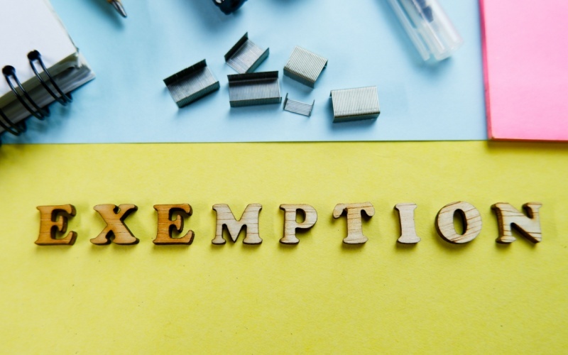 exemption in wood letters on desk