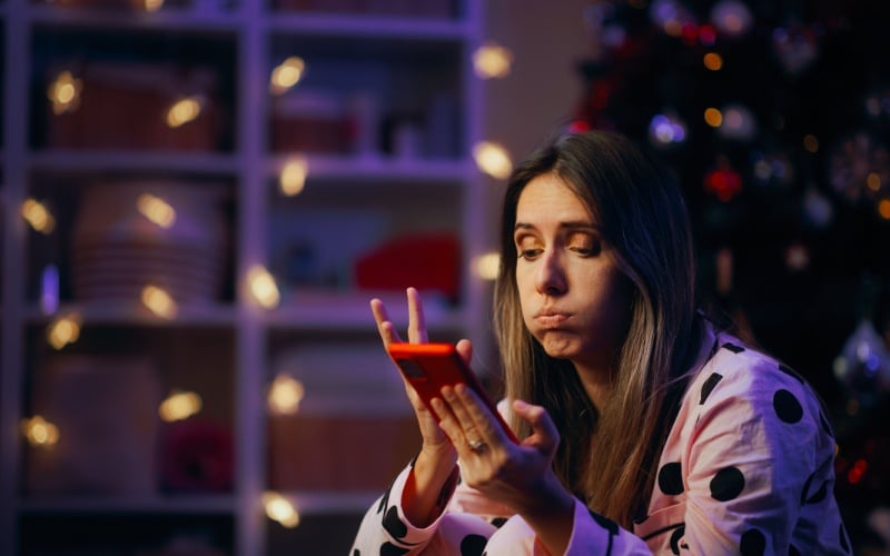 Woman Checking her Online Banking Account During Holidays