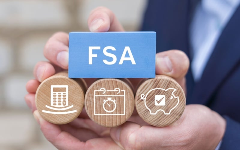 person holding blocks that read FSA with related icons