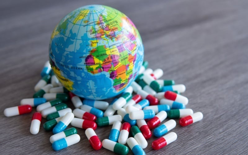 globe with prescription drugs around it
