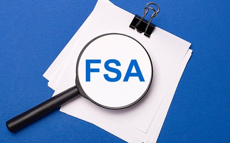 magnifying glass over words FSA on notepad