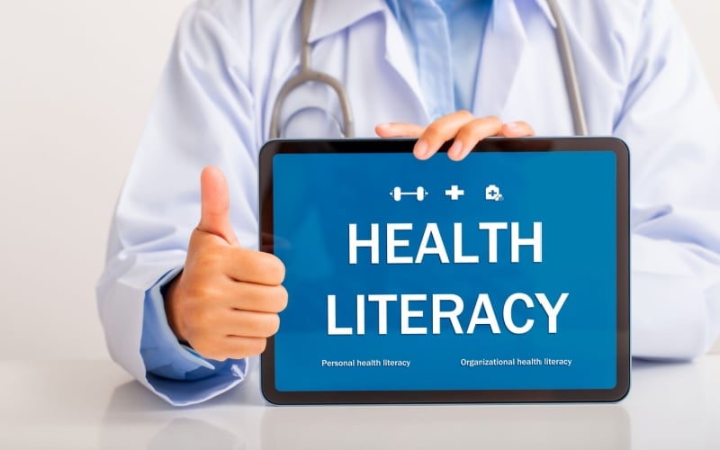 doctor holding iPad that reads health literacy