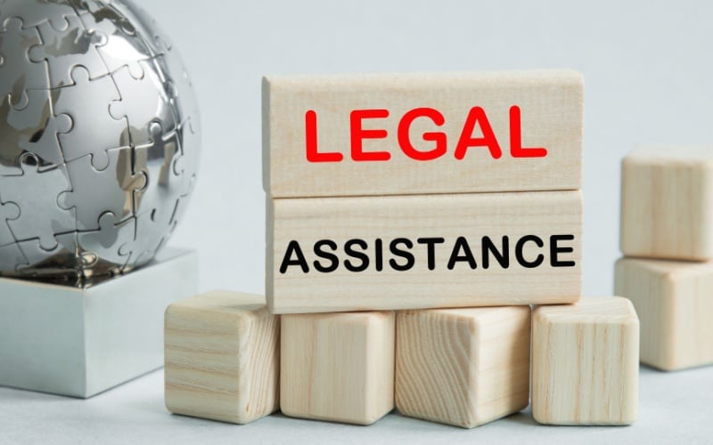 wooden blocks that say legal assistance
