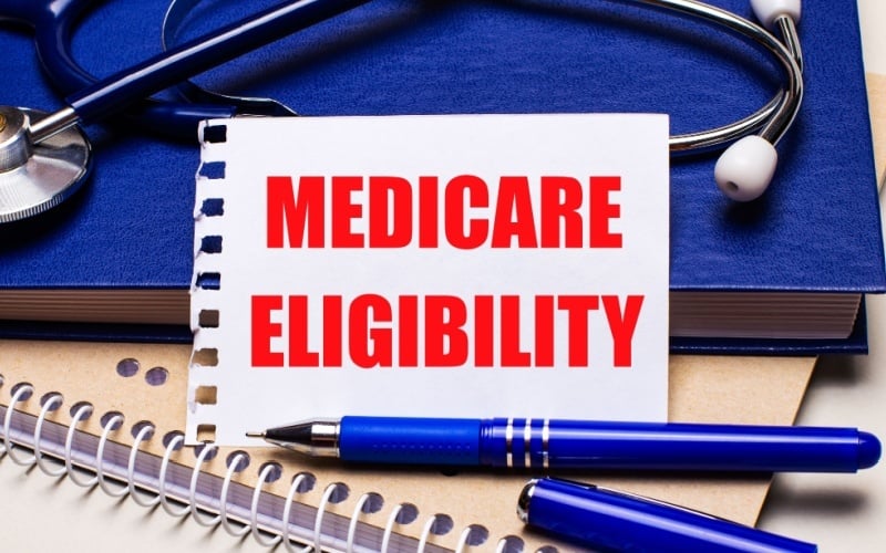 Medicare eligibility written on notebook paper on desk