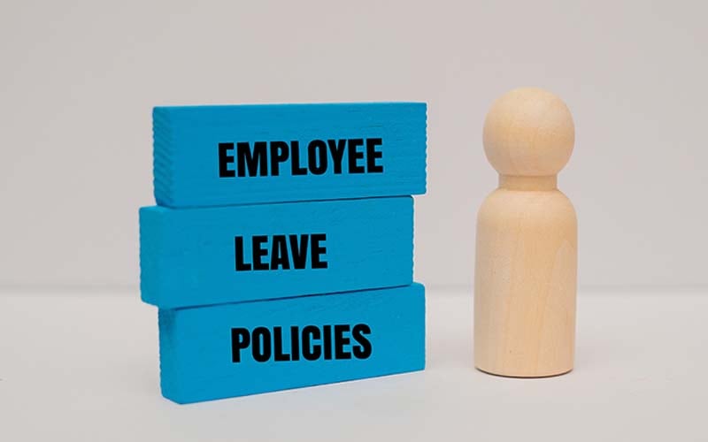 wood blocks that read employee leave policies