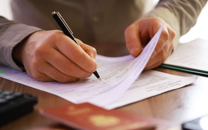 man filling out paperwork