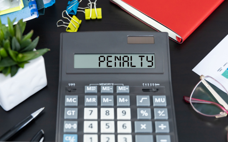words penalty on a calculator on desk