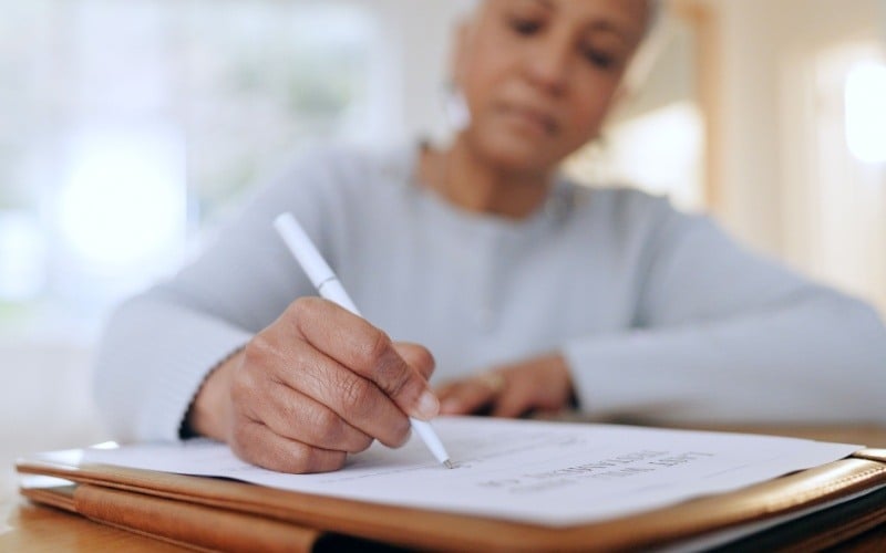 older woman filling out paperwork