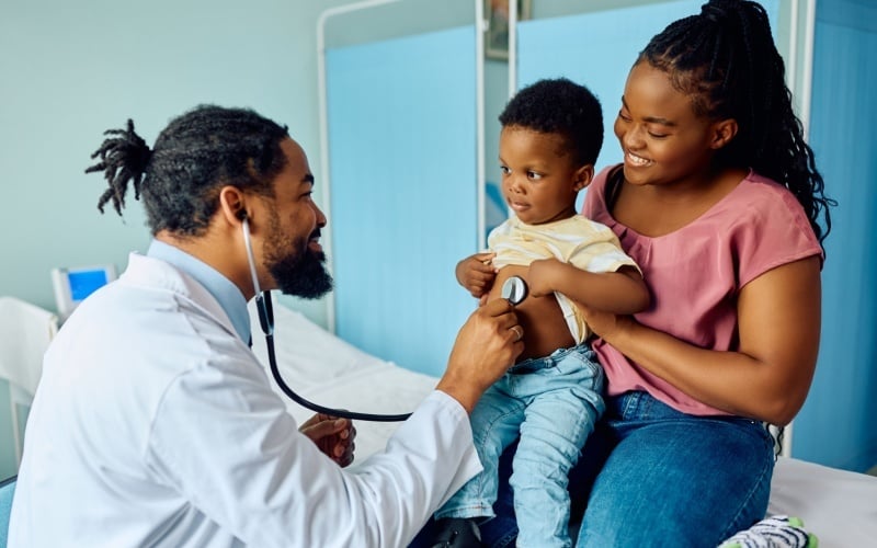 doctor with woman and child