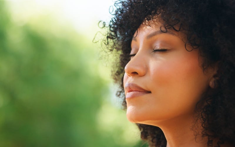 woman with eye closed reflecting