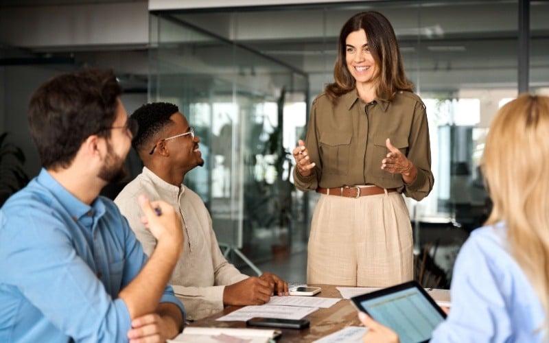 woman presenting to a group of employees